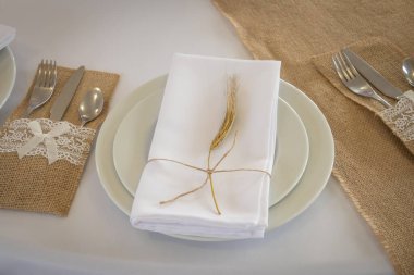 prepared table with plates and folded napkin