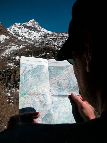 orientation in the mountains in the alps with a hiking map