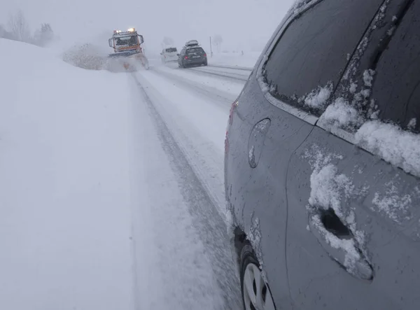 snow plow on a country road, traffic and mobility in winter