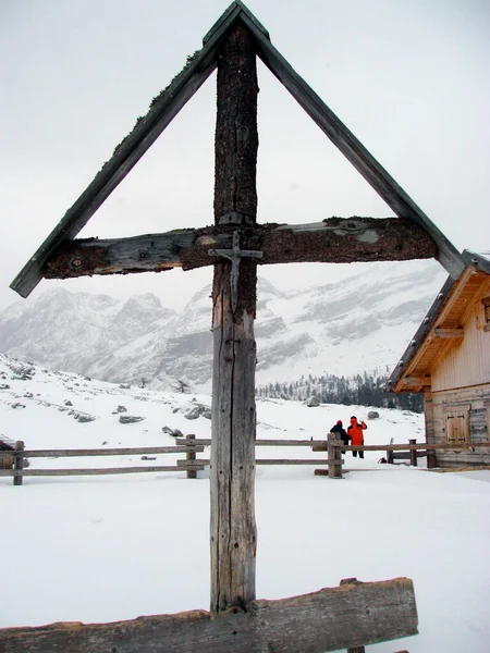 a wayside cross in christian religion in winter, showing Jesus Christ crucified