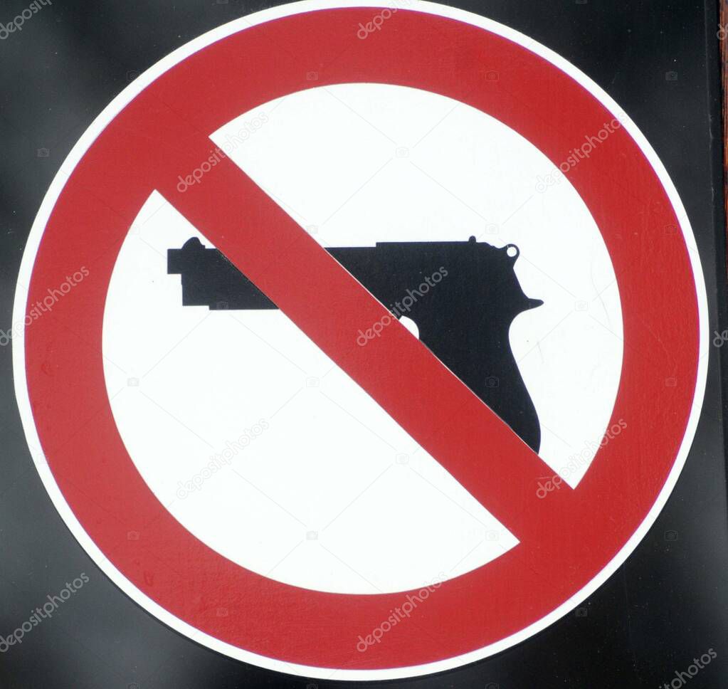 a prohibition of firearms sign, red circle and weapon pictogram