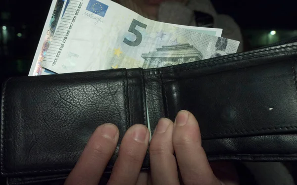 a wallet with euro bills, paying with cash in the european union