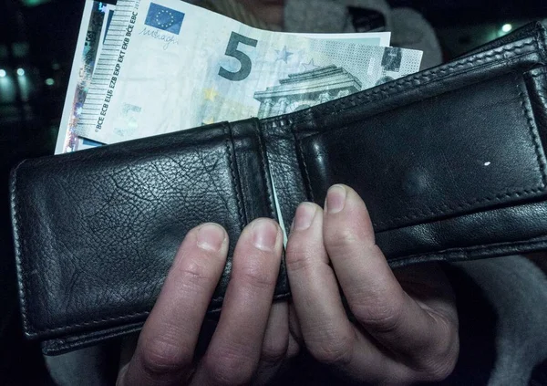 a wallet with euro bills, paying with cash in the european union