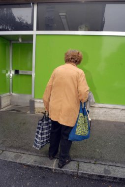 Yalnız yaşlı kadın alışverişini kumaş torbalarla yapıyor.