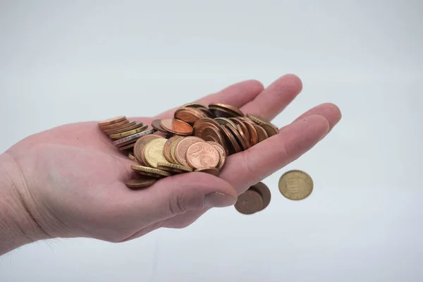 cash transaction hand with coins, cash payment in euro coins