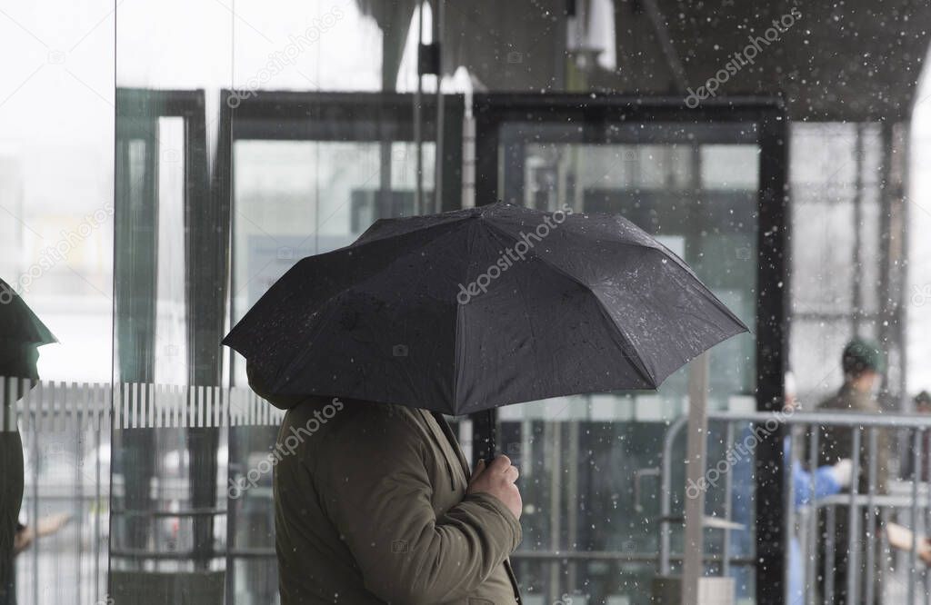 an umbrella as a protection against snow on the outside in winter