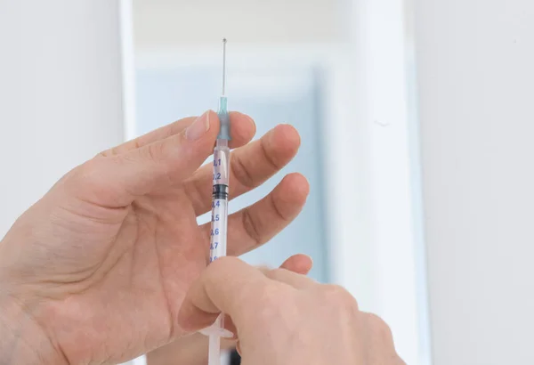vaccination by injection with a syringe, protection against dangerous diseases
