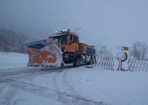 snow plow on a country road, traffic and mobility in winter