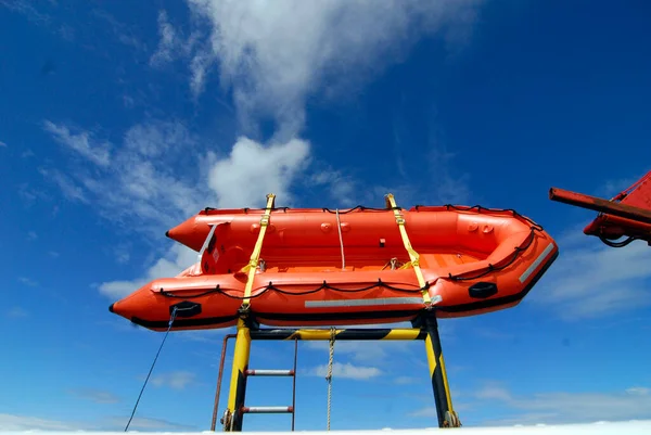 a red lifeboat or rescue boat as a safety device in seafaring