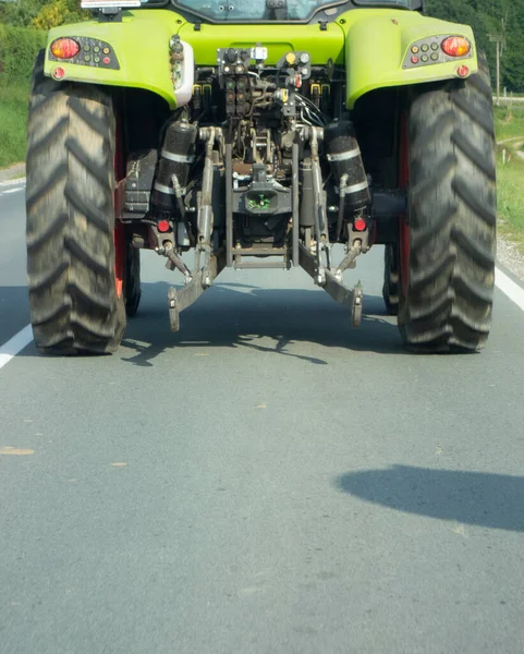 tractor on the country road, transportation and mobility in agriculture