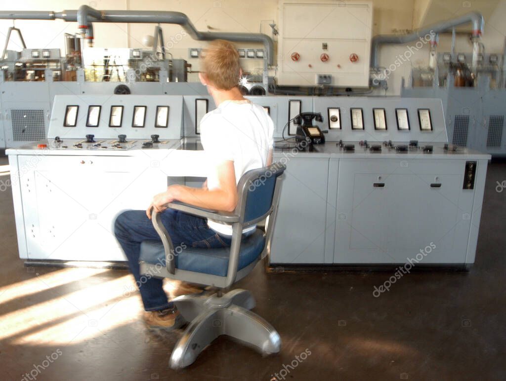 in an analog control room, controlling machines and working processes
