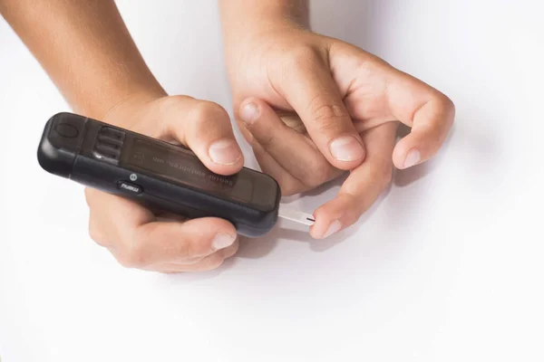 measuring the blood sugar level with a blood glucose meter