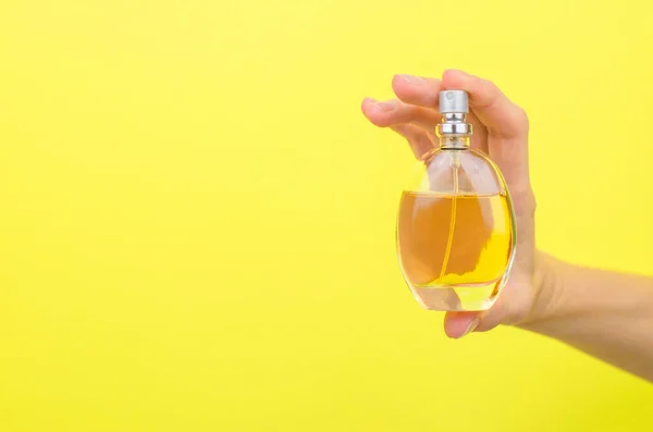 Perfume Bottle Female Hand Yellow Background — Zdjęcie stockowe