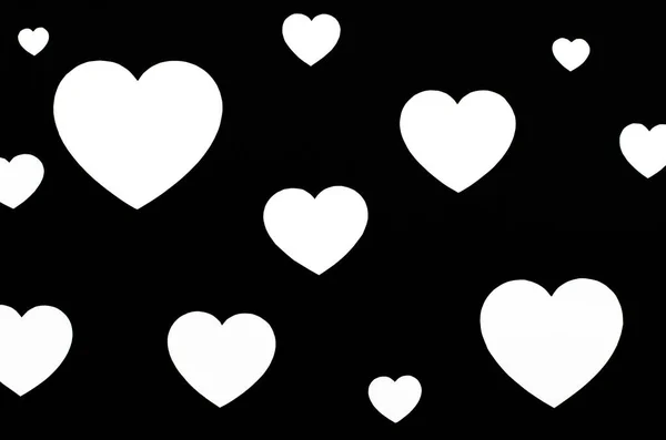 黒の背景に異なるサイズの白い心 バレンタインデーの背景 — ストック写真
