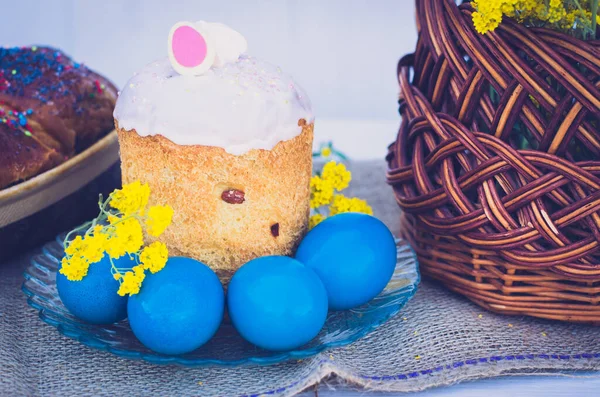 Easter eggs with Easter, flowers and a wicker basket. Religious holidays concept