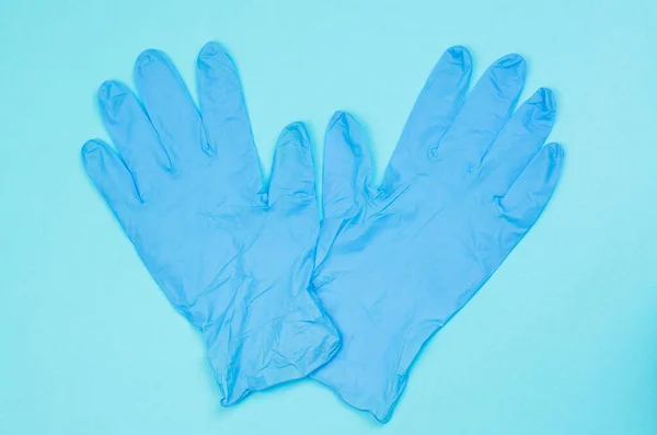 Guantes Médicos Azules Sobre Fondo Azul Claro —  Fotos de Stock