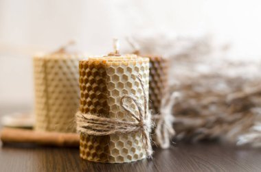 Dekorasyon için dekoratif mumlar. Koyu ahşap zemin üzerinde el yapımı mumlar ve saz dalları..