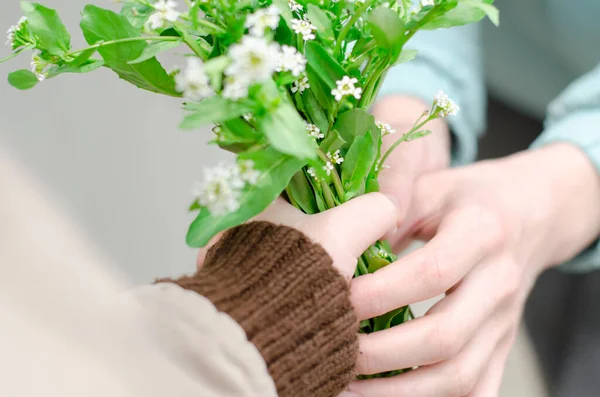 Son Gives His Mother Bouquet Wildflowers Close Mother Holiday Child — Stock Photo, Image