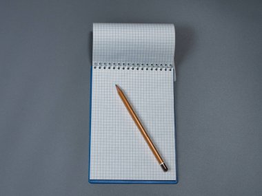 Kalemle kafesin içinde not defterini aç.