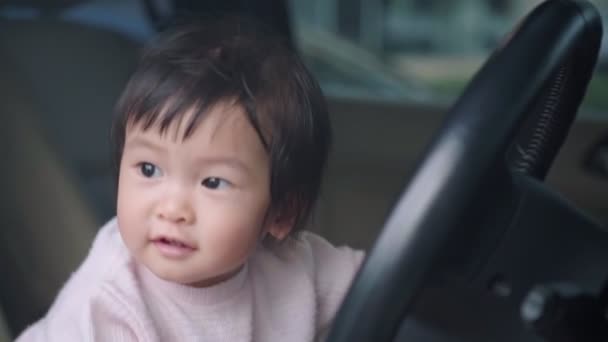 Cute Asian Female Toddler Sitting Car Driver Front Seat Playing — Stock Video