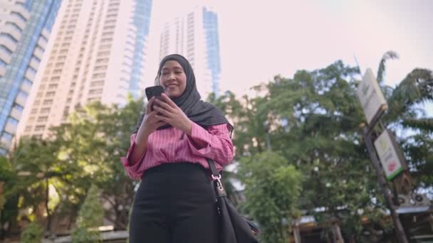Привлекательный Счастливый Азиат Мусульманин Стоя Играть Мобильный Телефон Приложение Восхищением — стоковое видео