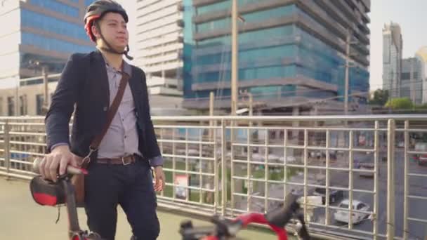 매력적 사업가가 마치고 도시로 돌아오는 자전거를 즐겁게 밀면서 도시의 에너지 — 비디오
