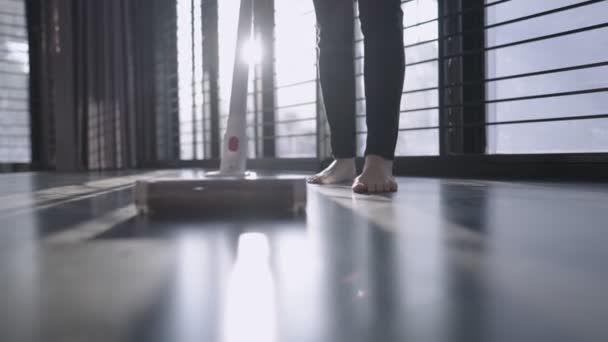 Low Angle Shit Young Female Using Vacuum Cleaner Sweeping Dusty — Vídeo de stock