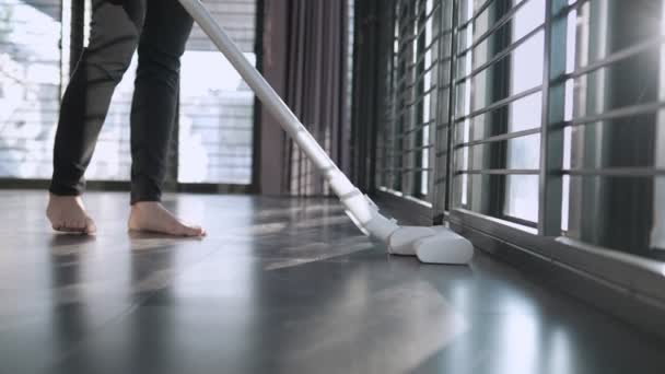 Low Angle Shit Young Female Using Vacuum Cleaner Sweeping Dusty — Vídeo de stock