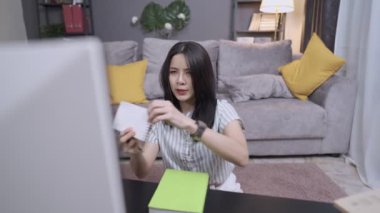 Ciddi kadın öğretmenler evden ders planlama, ders kitabı okuma, rahat oturma odasında oturma odasında oturup kablosuz kulaklık kullanma, internetten öğrenme, uzak internet işi, eğitim portatif bilgi aygıtı gibi konularda çalışırlar.