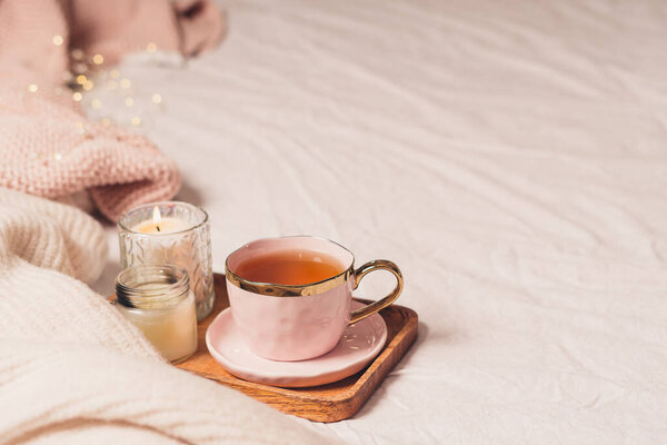 Cup of tea, cotton, cozy, book, candle. Cosy autumn winter concept.