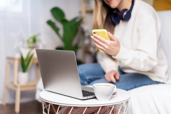 Woman with laptop and phone