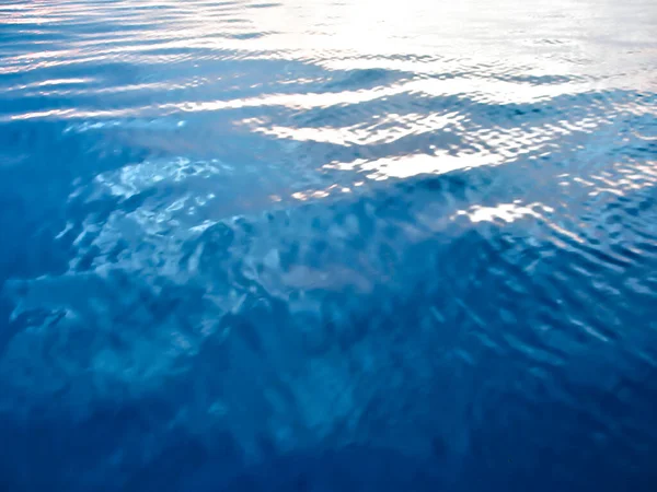 Perfectly calm ocean surface in evening light, an abstract vision.