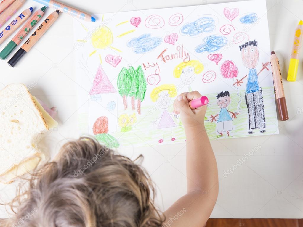 Little girl painting a pink dress of a girl in a kids drawing of