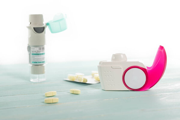 Set of asthma inhaler, anti-allergy pills and aerosol machine with inhaler mask,concept asthma and treatment on white background,copy space.
