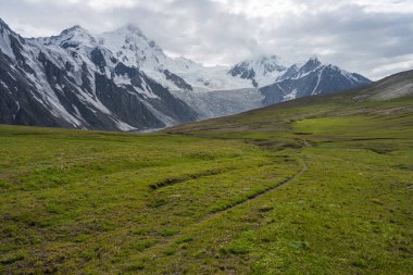 Trekking trail in Patundas trekking route with Passu glacier in background, Karakoram mountains range in Pakistan, Asia clipart