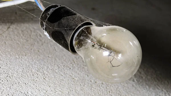 Old socket for incandescent light bulb on the wall