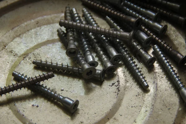 Metal screws in a metal box