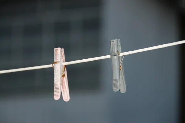 Colored clips and clothespins on the lace after the rain