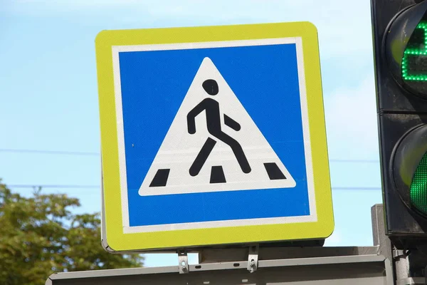 Road sign of a pedestrian crossing on the street