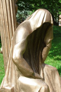 Sculpture of a young man made of concrete in the park