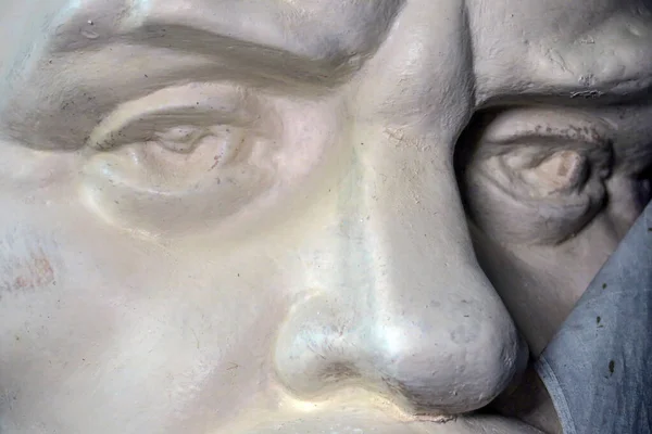 The face of a man made of plaster is a white monument