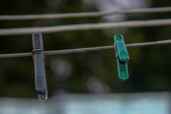 Colored clips and clothespins on the lace after the rain