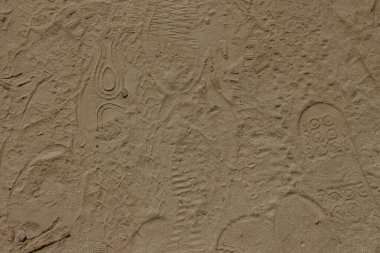 Footprints on the sand and shade from the sun