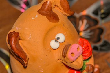 Bir çiçeğe aşık şaşı gözlü domuz yavrusu ve pençelerinde kırmızı bir kalp Sevgililer Günü 'nü ve 8 Mart Sevgililer Günü' nü, Anneler Günü 'nü kutluyor.