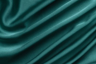 Yeşil ipeğin yaratıcı arka planı. Soyut doku seçmeli odak.