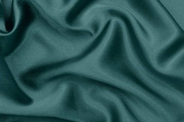 Creative background of green silk. Abstract texture. Selective focus. clipart