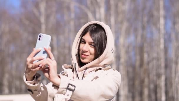 Happy Brunette Girl Takes Pictures Herself Smartphone Camera While Walking — Stock Video