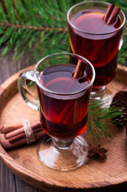 Mulled wine, cinnamon sticks, anise stars, fir cones and branches clipart