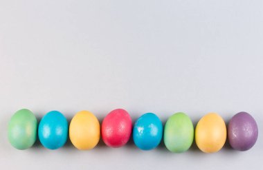 Gri arkaplanda renkli paskalya yumurtaları.