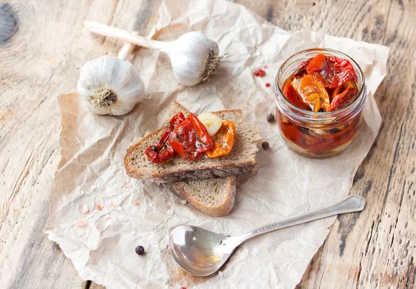 Fresh bread with sun-dried tomatoes on a wooden table. — Stock Photo, Image